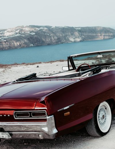 Classic 1966 Pontiac Parisienne convertible at the edge of the Santorini caldera